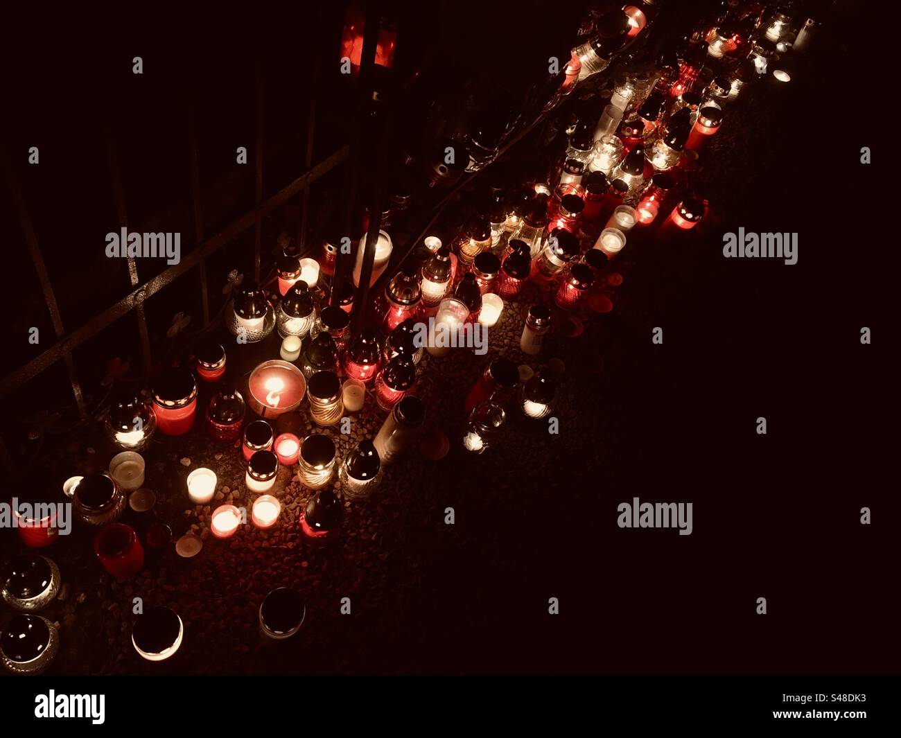 Candles burning on All Saints Day in cemetery - Smartphone Captured Stock Image