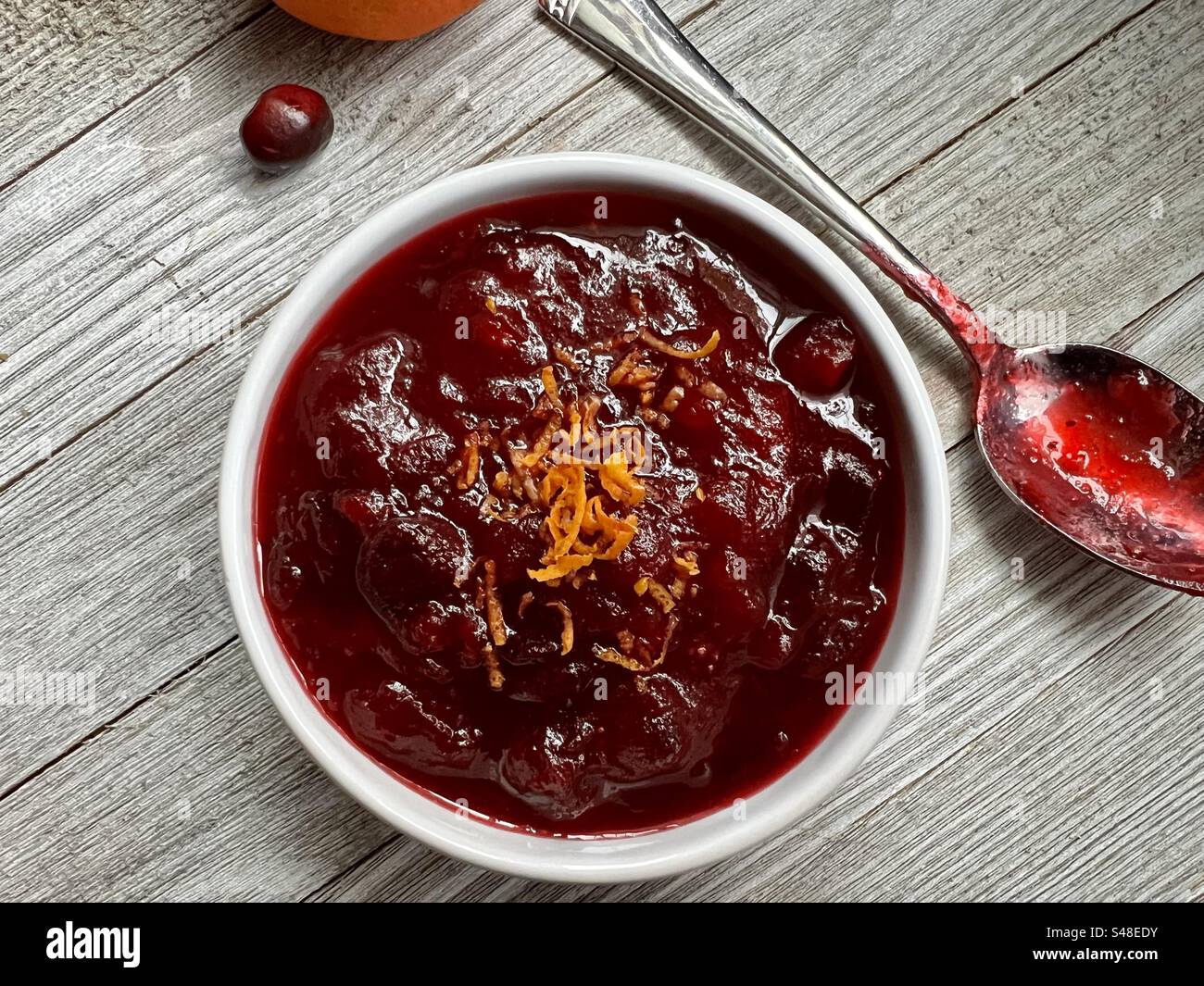 Homemade cranberry sauce in a white bowl viewed from above Stock Photo