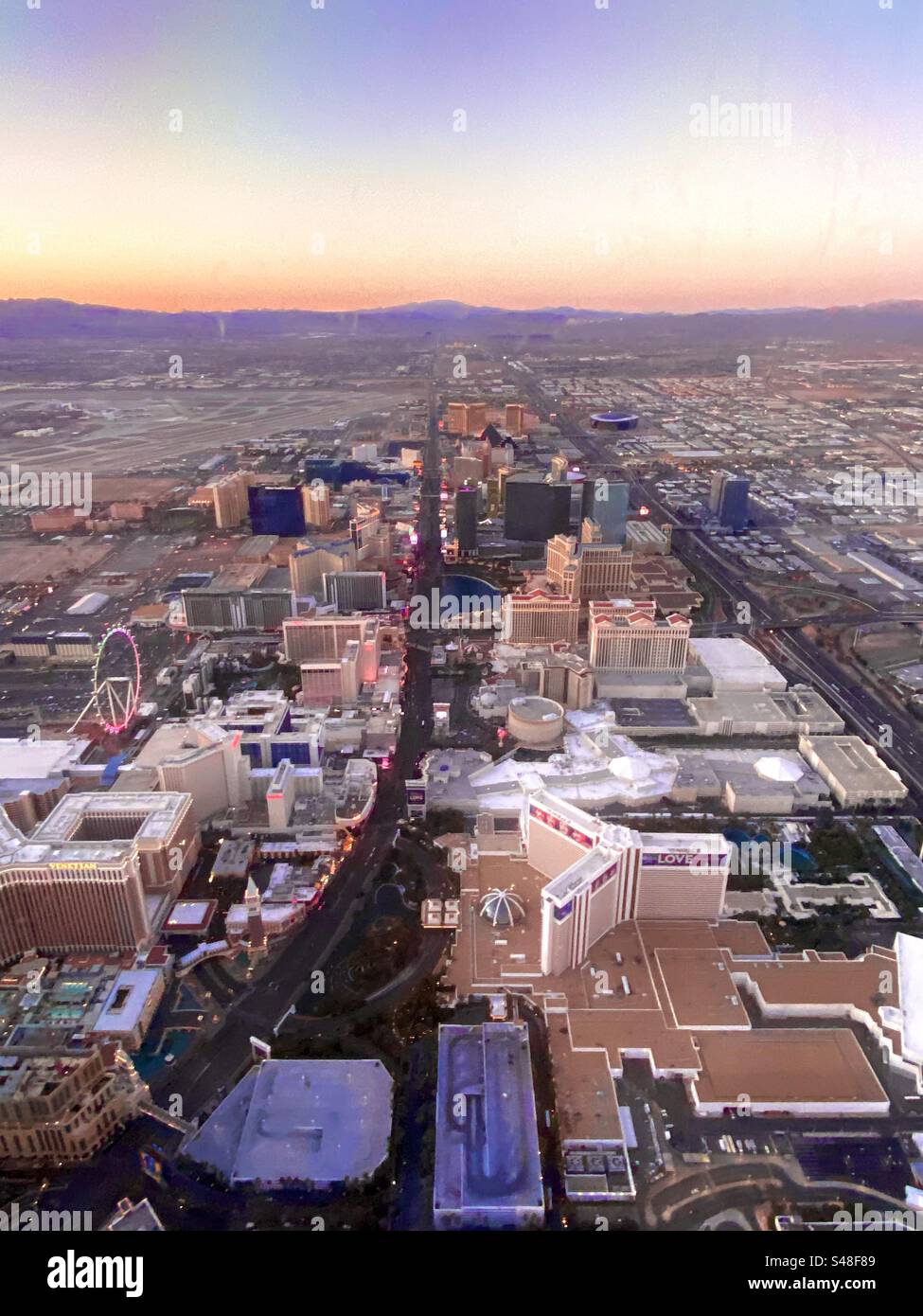 Aerial view of a glowing horizon and Las Vegas during sunrise. - Smartphone Captured Stock Image