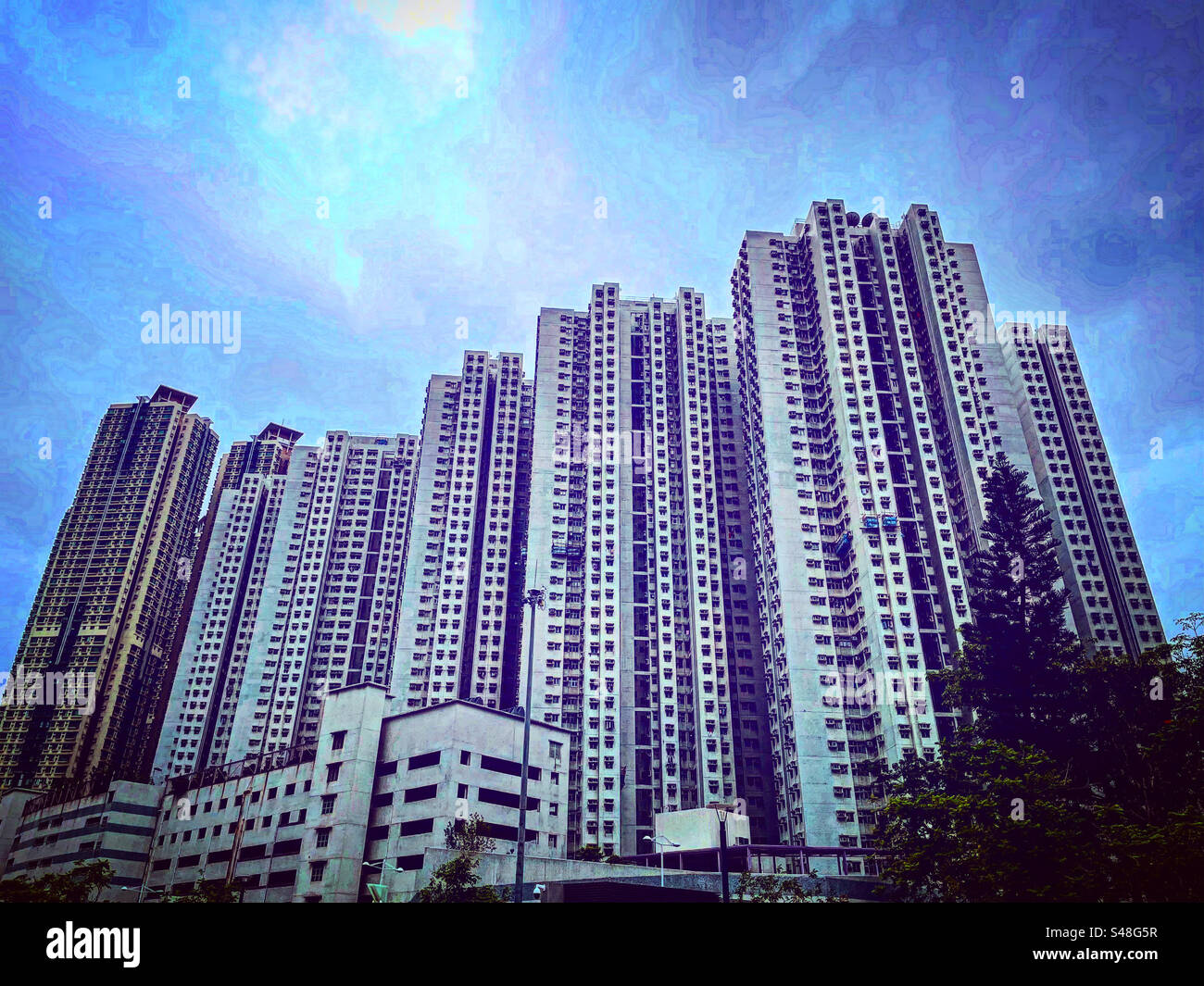 block of towers buildings in hk hong kong forming a complex of council flats and appartment for people to rent for chesper in this real estate markets of rich asia - Smartphone Captured Stock Image