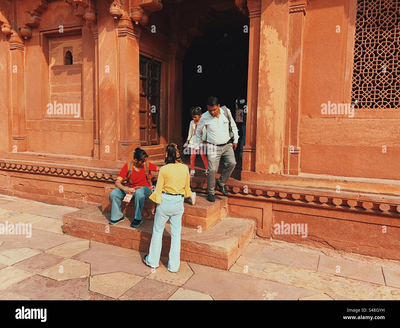 Tourists exploring the historic palace in Fatehpur Sikri near Agra - Smartphone Captured Stock Image