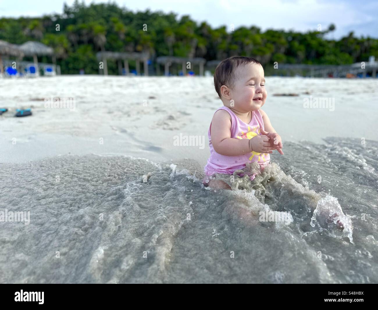 Wave touches baby’s feet at the shore at Varadero beach - Smartphone Captured Stock Image