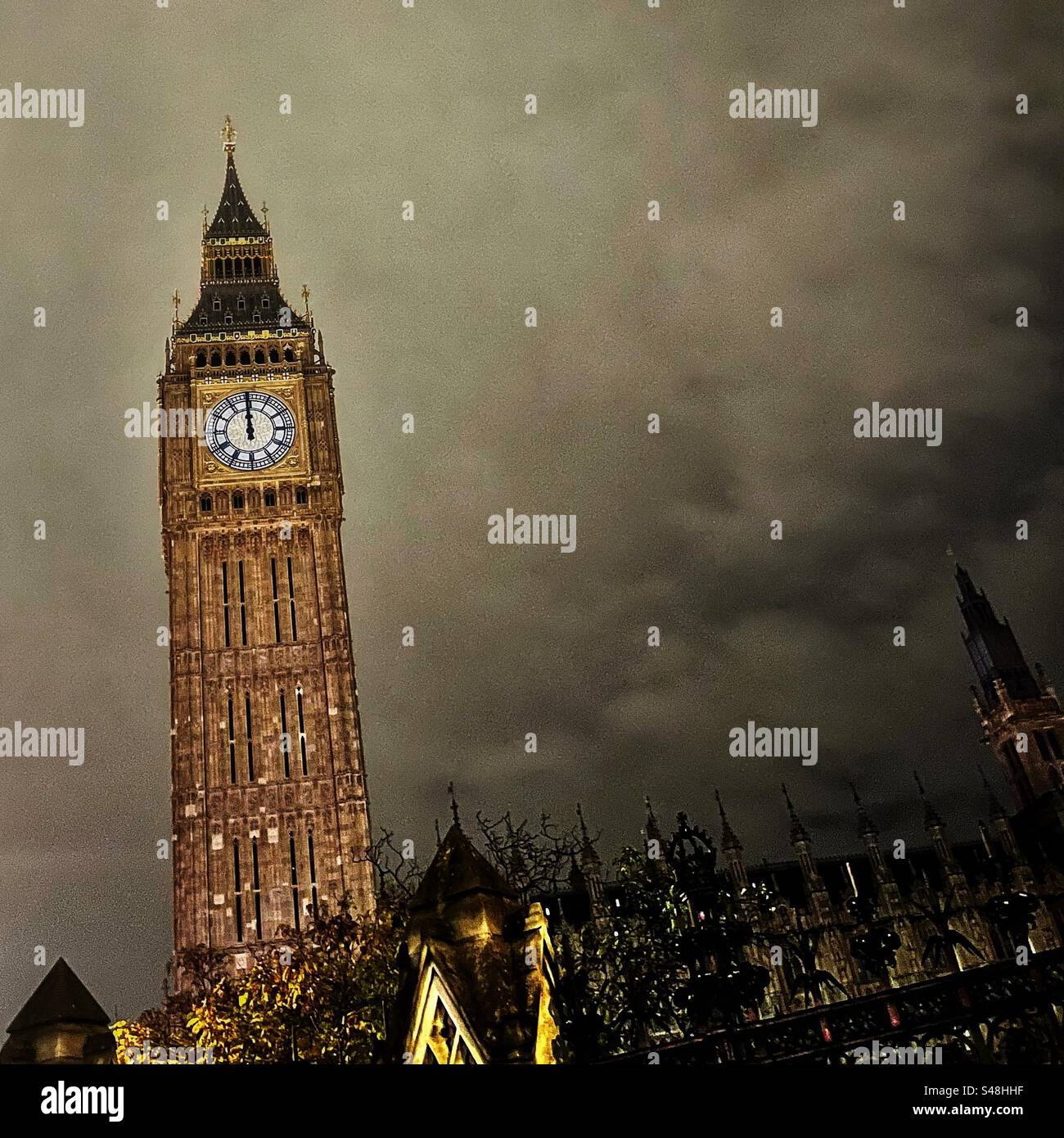 Big Ben at midnight looking at the clock tower from the perimeter of Parliament in London - Smartphone Captured Stock Image