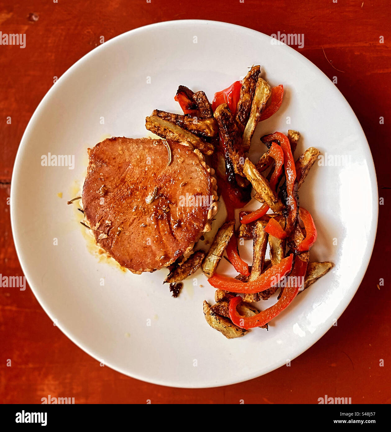 Fried red peppers and potatoes with a grilled tuna fish filet in Queretaro, Mexico Stock Photo