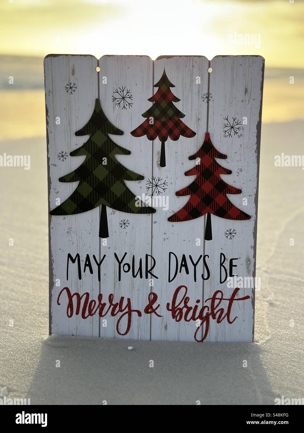 Christmas plaque May your days be merry and bright with vibrant beach sunset background - Smartphone Captured Stock Image