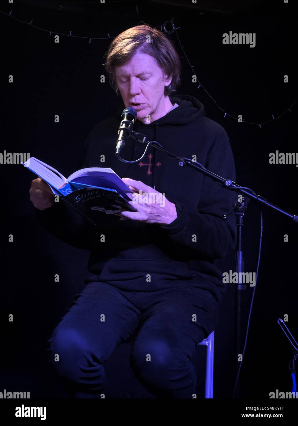 Singer, songwriter, author and frontman of the legendary band, Sonic Youth, Thurston Moore, reading from his book of memoirs, called Sonic Life, at Bristol Rough Trade record store, November 18th 2023 - Smartphone Captured Stock Image