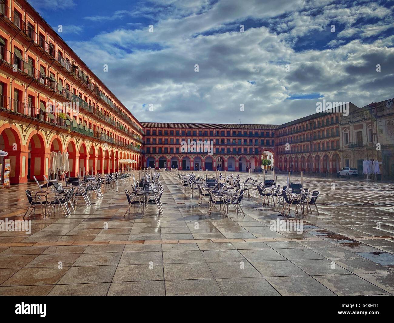 Corredera Square in Cordoba with sunshine and wet pavement after the rain, Spain. Stock Photo