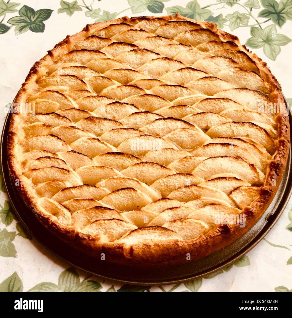 Shot of a beautiful Apple pie on a leafy table top - Smartphone Captured Stock Image