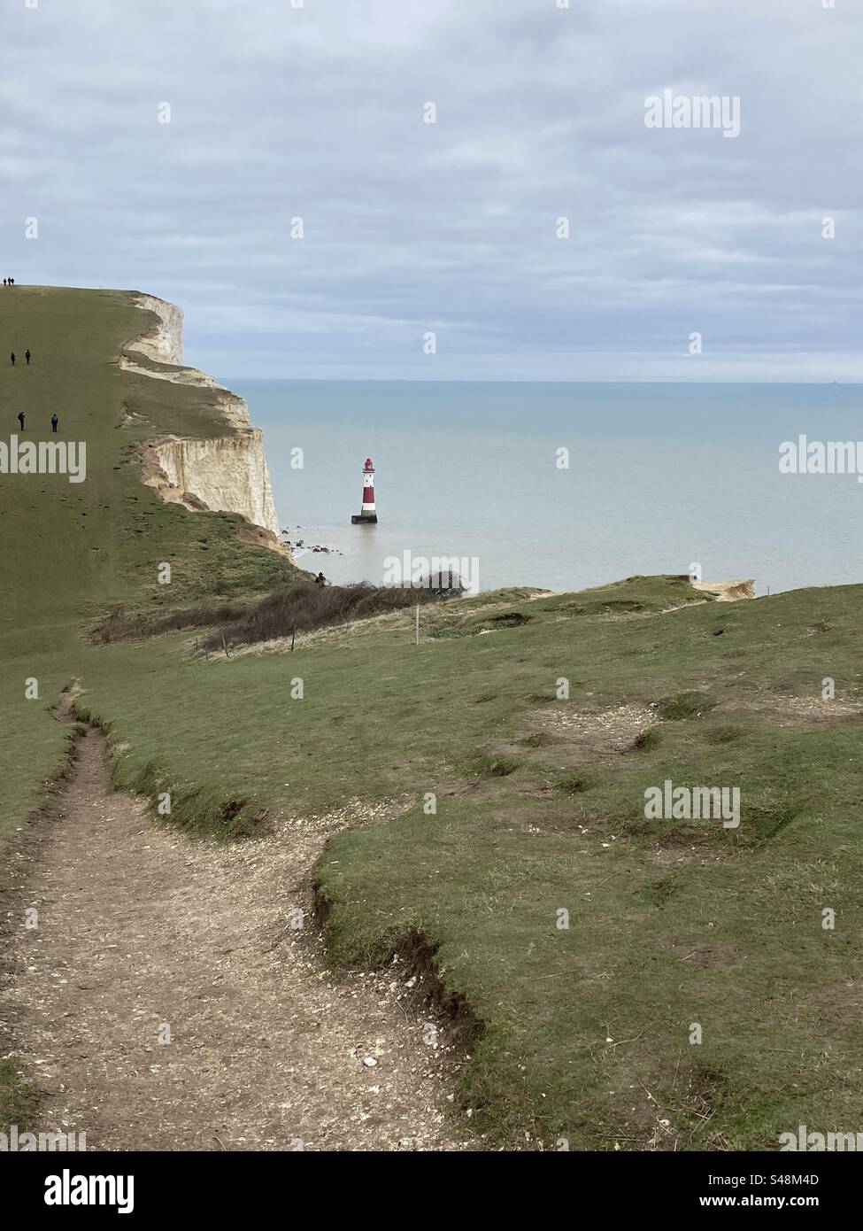 Beachy Head lighthouse as seen from the cliff side walk on the South Downs Way in Eastbourne, East Sussex - Smartphone Captured Stock Image