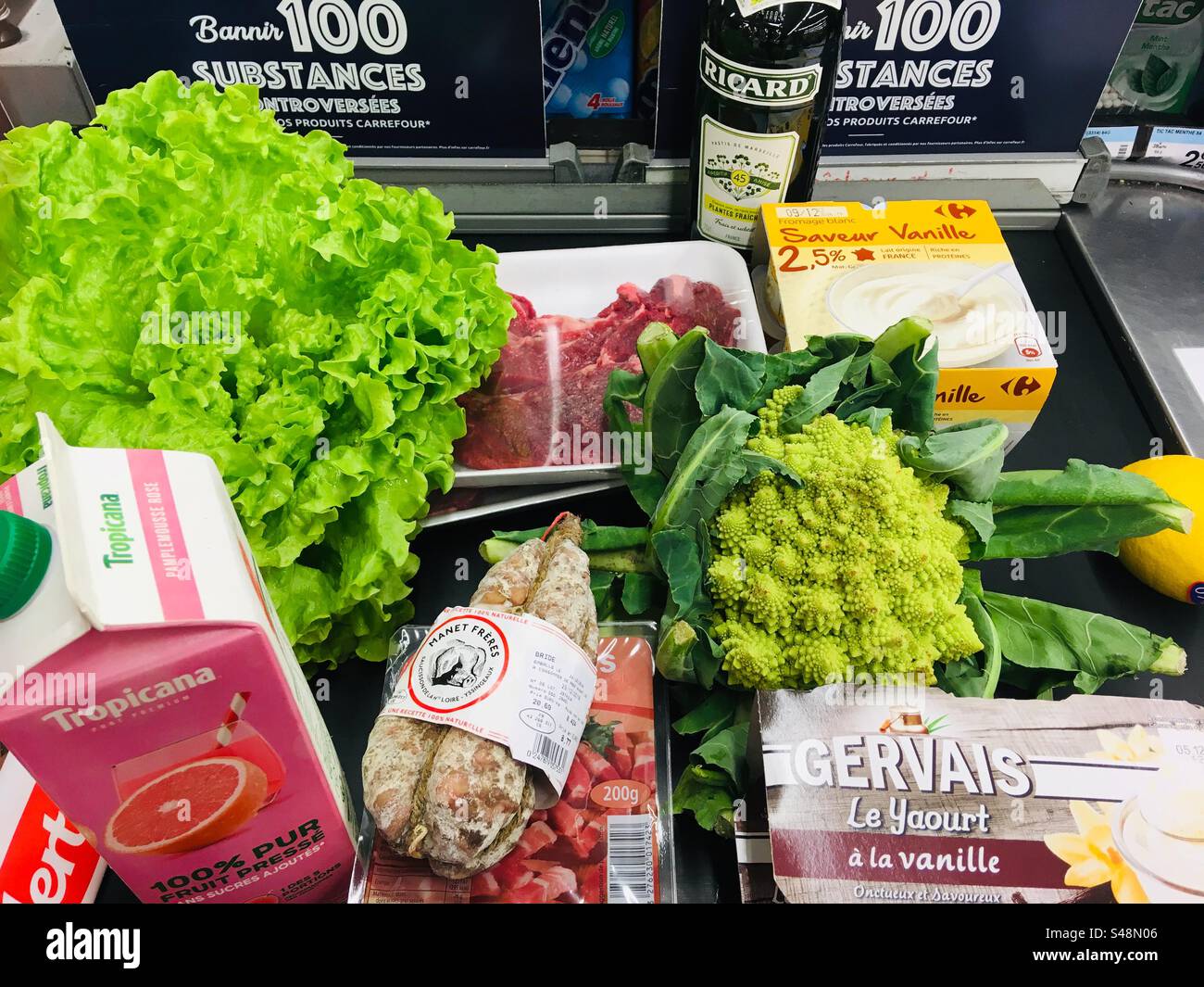 Shot of an assortment of grocery items on a store conveyor belt Stock