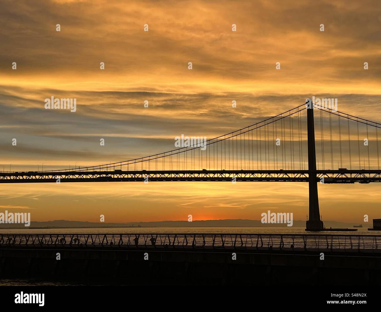 Golden autumn sunrise behind the San Francisco Bay Bridge Stock Photo