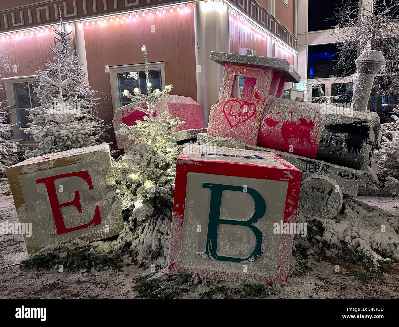 A toy train and alphabet blocks covered in fake snow at Liseberg theme park, Gothenburg, Sweden. - Smartphone Captured Stock Image