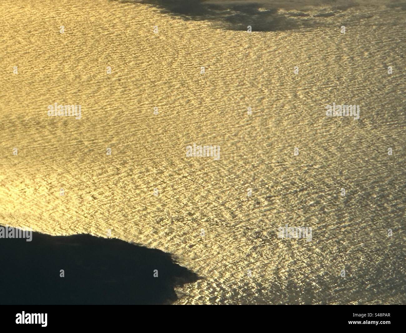 Golden ocean waves off the west coast of Canada at dawn from 33000 feet - Smartphone Captured Stock Image