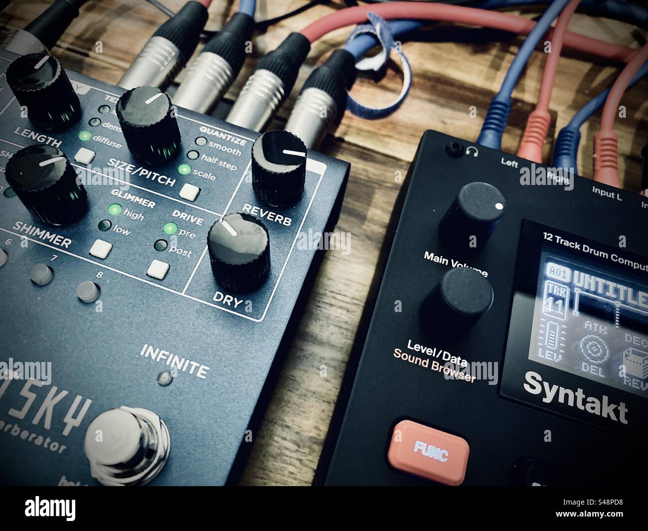 Elektron Syntakt synthesiser and Strymon NightSky reverb effects FX pedal. Audio cables connecting the devices are also visible. - Smartphone Captured Stock Image Elektron Syntakt synthesiser and Strymon NightSky reverb effects FX pedal. Audio cables connecting the devices are also visible. - Smartphone Captured Stock Image