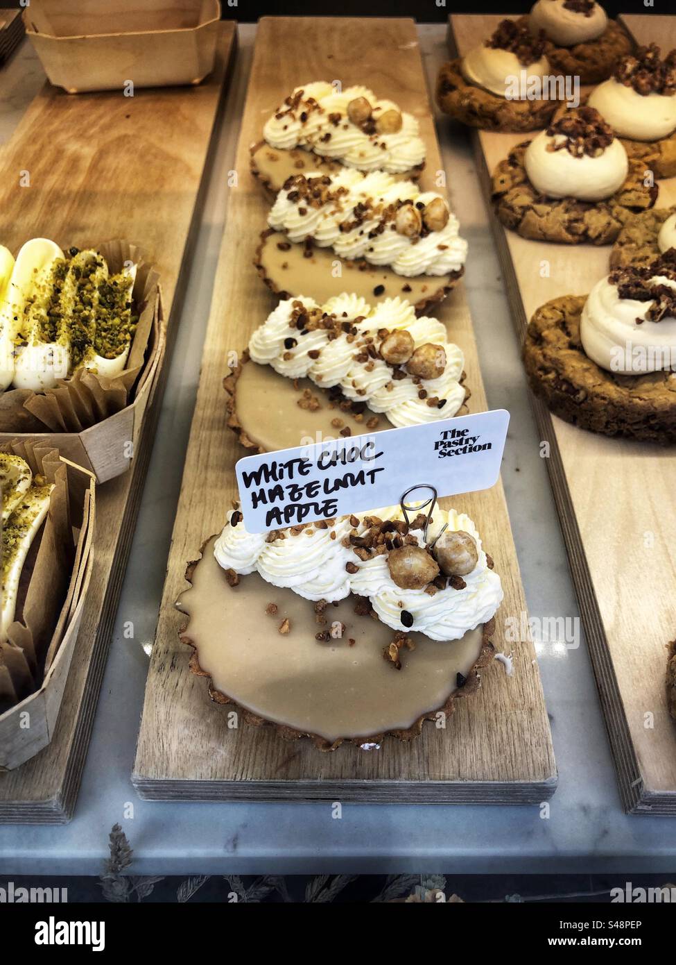 White chocolate hazelnut apple tart cake in bakery shop window - Smartphone Captured Stock Image