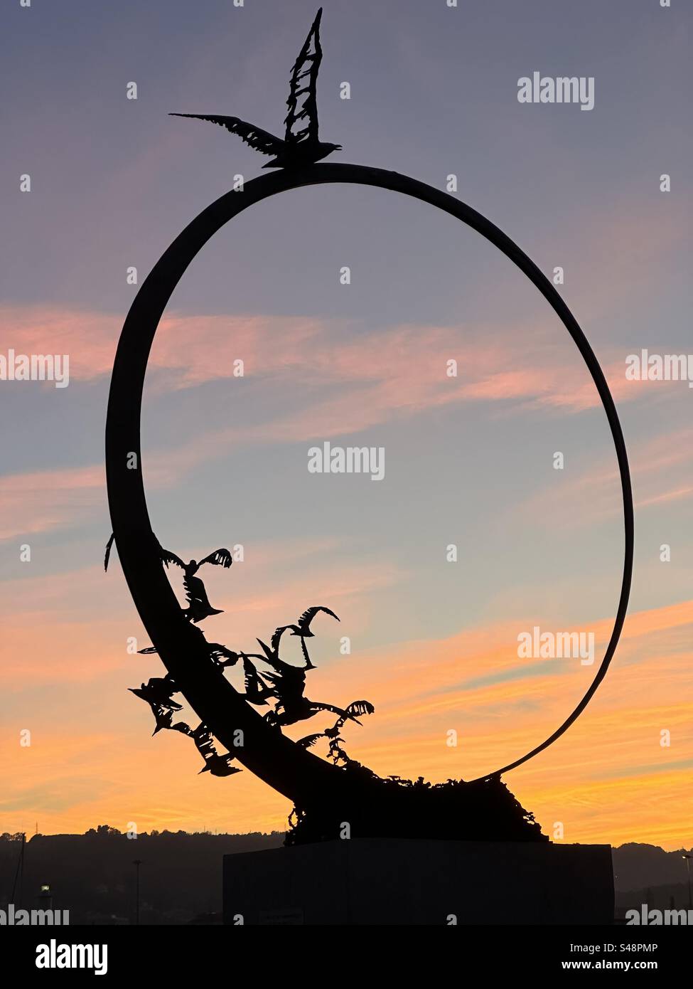 Sunset behind the Jonathan Seagull Monument located along the southern pier promenade of San Benedetto del Tronto, Marche region, Italy - Smartphone Captured Stock Image