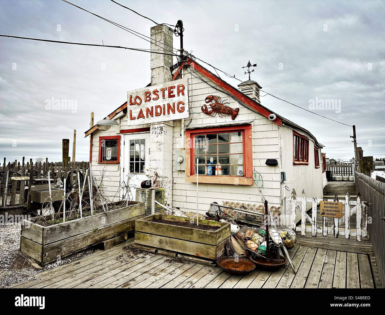 Lobster Landing in Clinton, Connecticut, USA.  Local business and restaurant with sign.  View of building exterior on a cloudy, spring day. - Smartphone Captured Stock Image