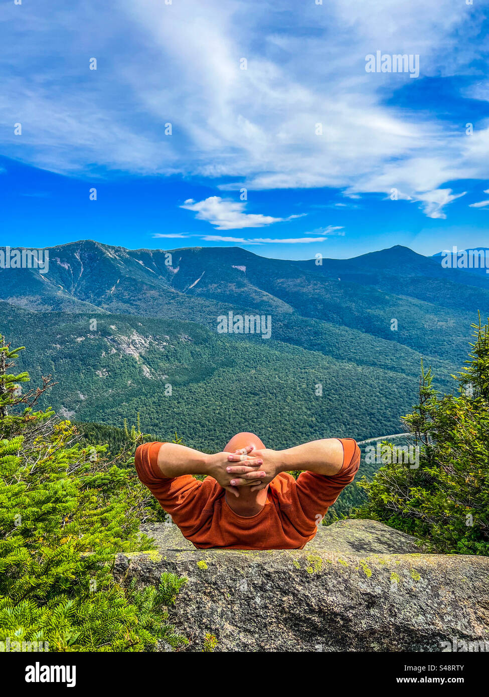 A man enjoys the view atop Cannon Mountain at Franconia Notch State Park on September 17, 2023. - Smartphone Captured Stock Image
