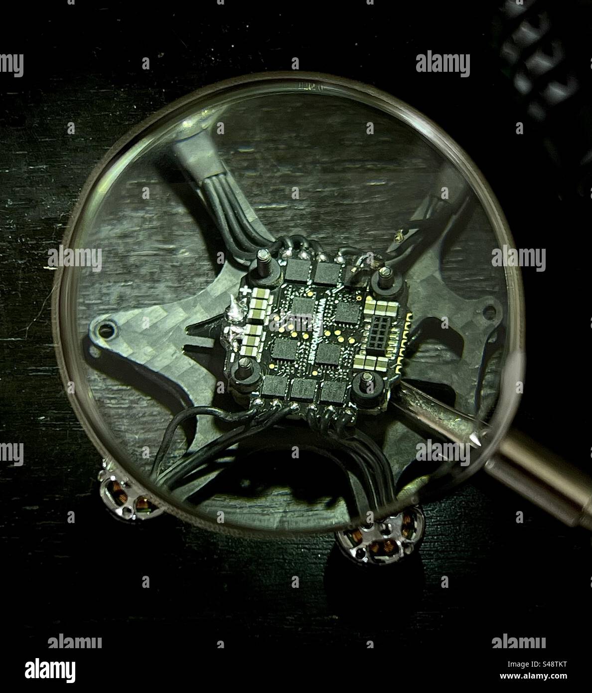 Macro close-up shot of a micro drone main electronic board being worked on. - Smartphone Captured Stock Image