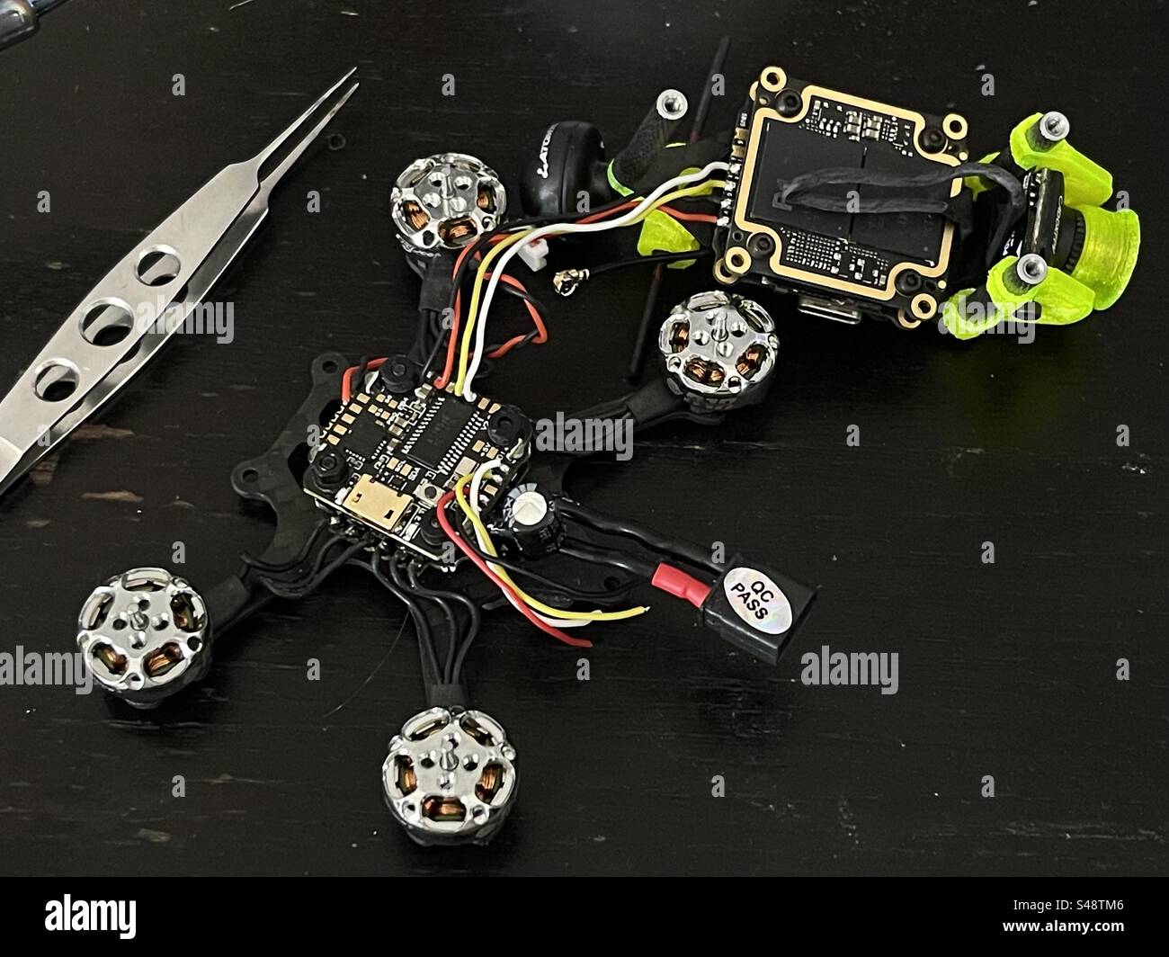 Shot of disassembled micro FPV drone, with the camera removed and sweepers. - Smartphone Captured Stock Image