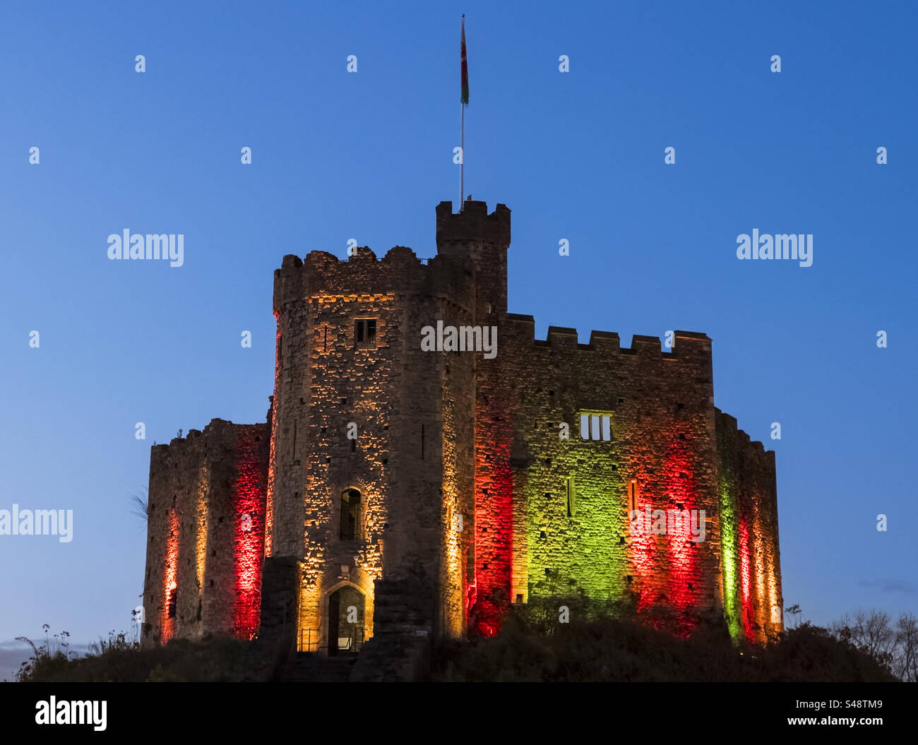 Cardiff Castle illuminated in red and green at the 2024 Christmas festival, Cardiff, Wales: Phillip Roberts - Smartphone Captured Stock Image