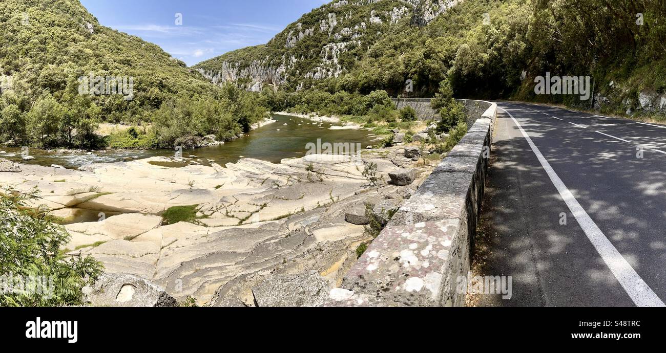 Panoramic view of the Hérault river valley near Ganges, with flag rocks and the road nearby. - Smartphone Captured Stock Image