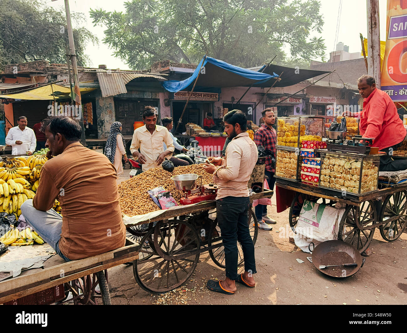 An Indian market scene full of shops and street vendors selling fruits and eatables - Smartphone Captured Stock Image