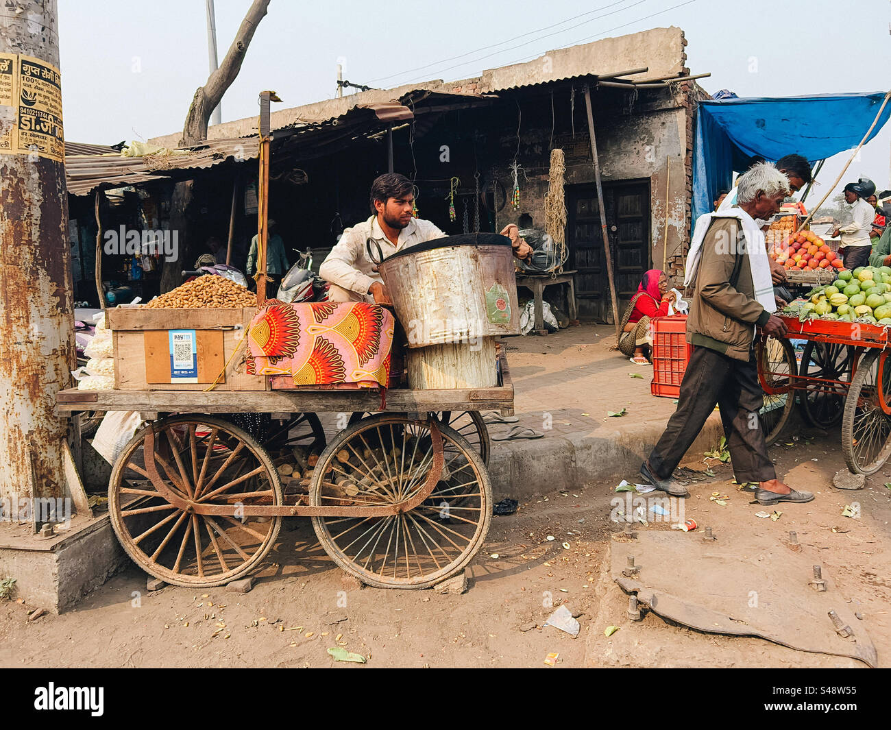 An Indian market scene full of shops and street vendors selling fruits and eatables - Smartphone Captured Stock Image