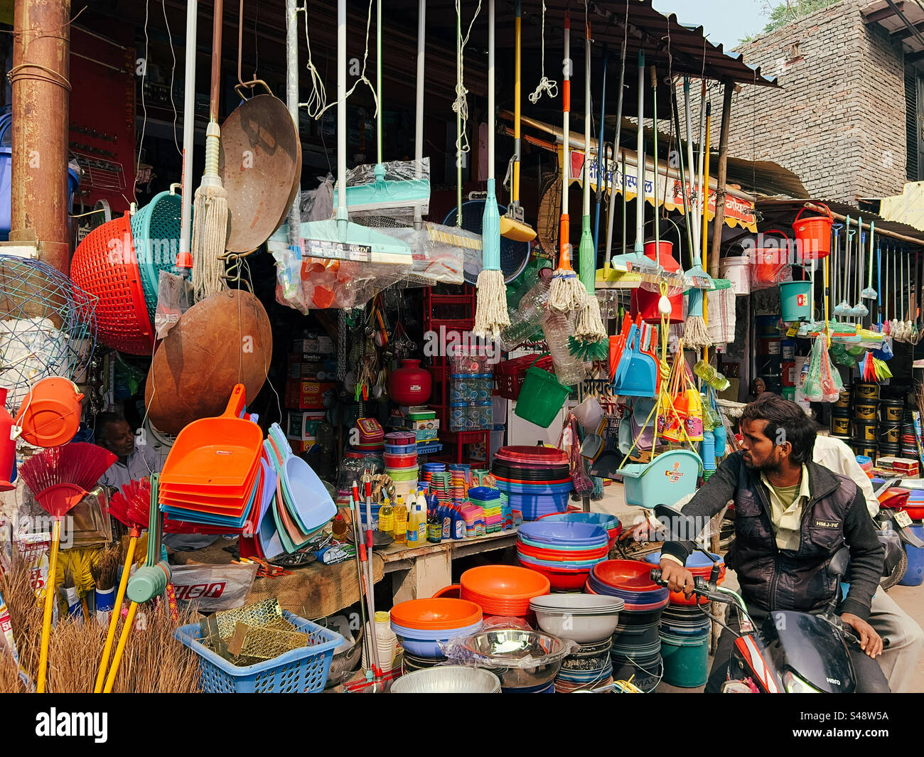 A shop in a market along a street in India selling plastic products for cleaning and other purposes - Smartphone Captured Stock Image