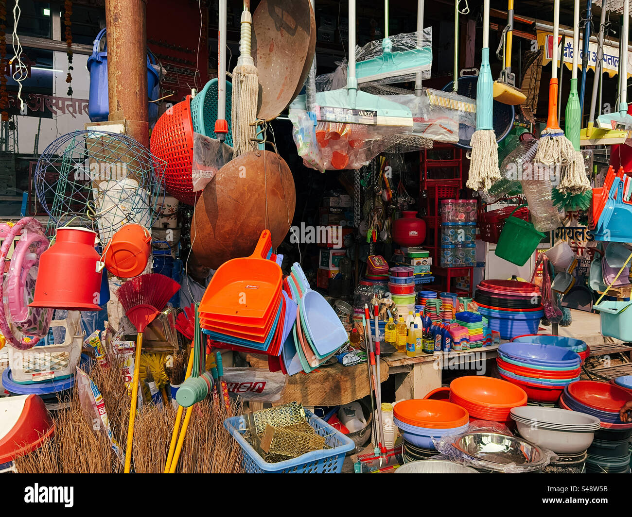 A shop in a market along a street in India selling plastic products for cleaning and other purposes - Smartphone Captured Stock Image