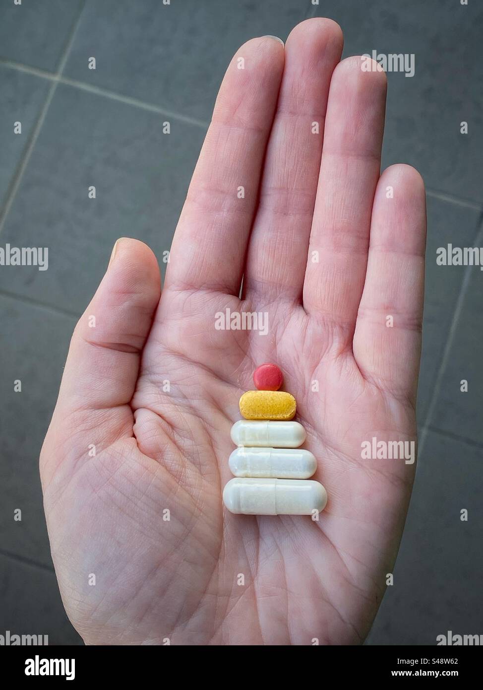 A hand with pills Xmas edition - Smartphone Captured Stock Image