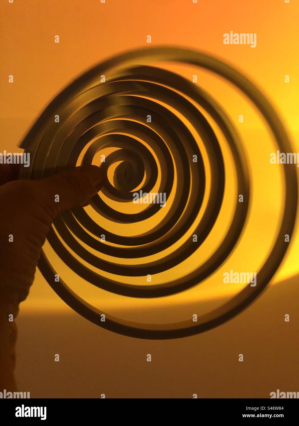 Surreal Image of a hand holding a spiral - Smartphone Captured Stock Image