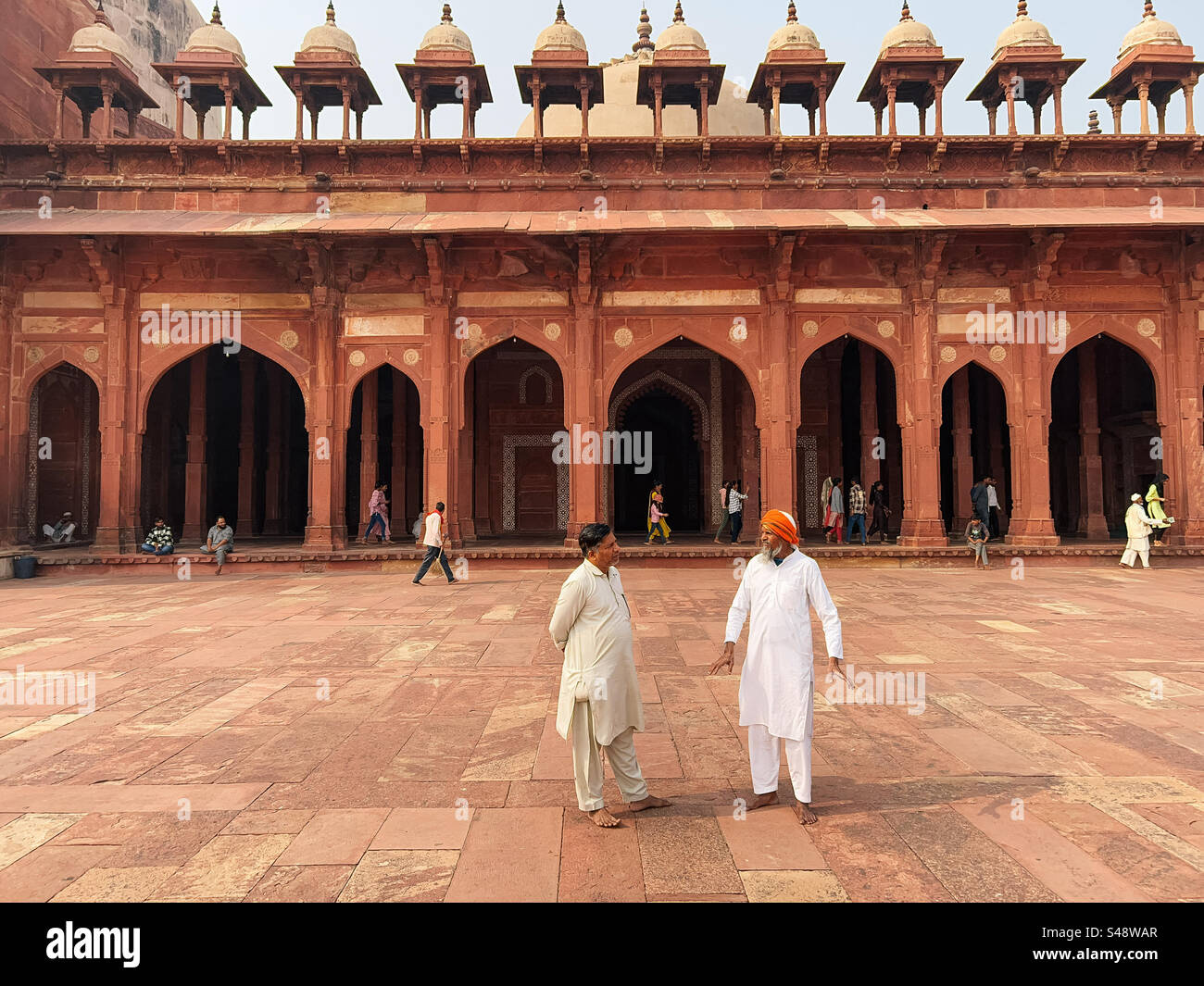 Indian Muslim men at the Sufi shrine at the mosque in Fatehpur Sikri in Uttar Pradesh in India Stock Photo