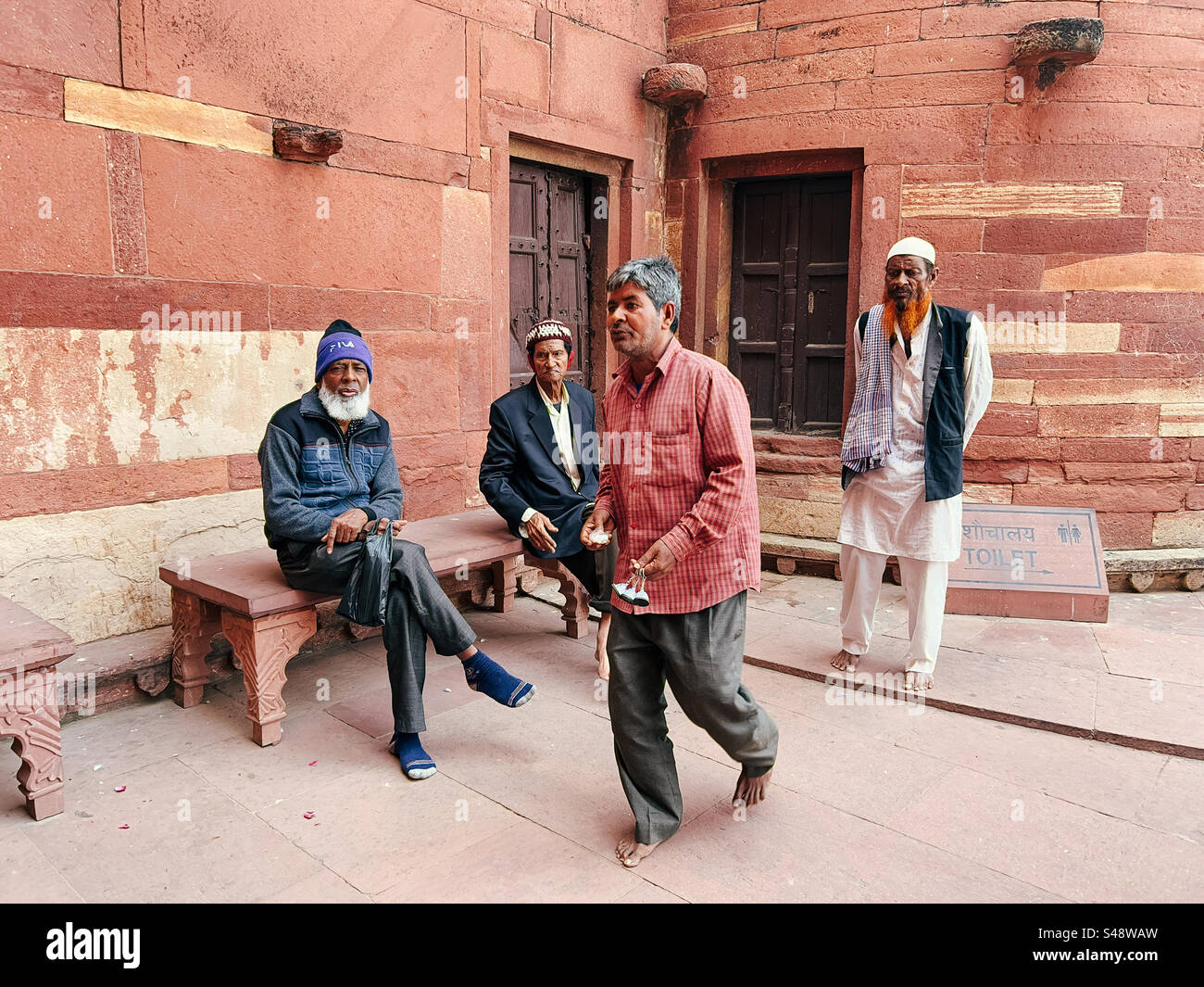 Indian Muslim men at the Sufi shrine at the mosque in Fatehpur Sikri in Uttar Pradesh in India Stock Photo