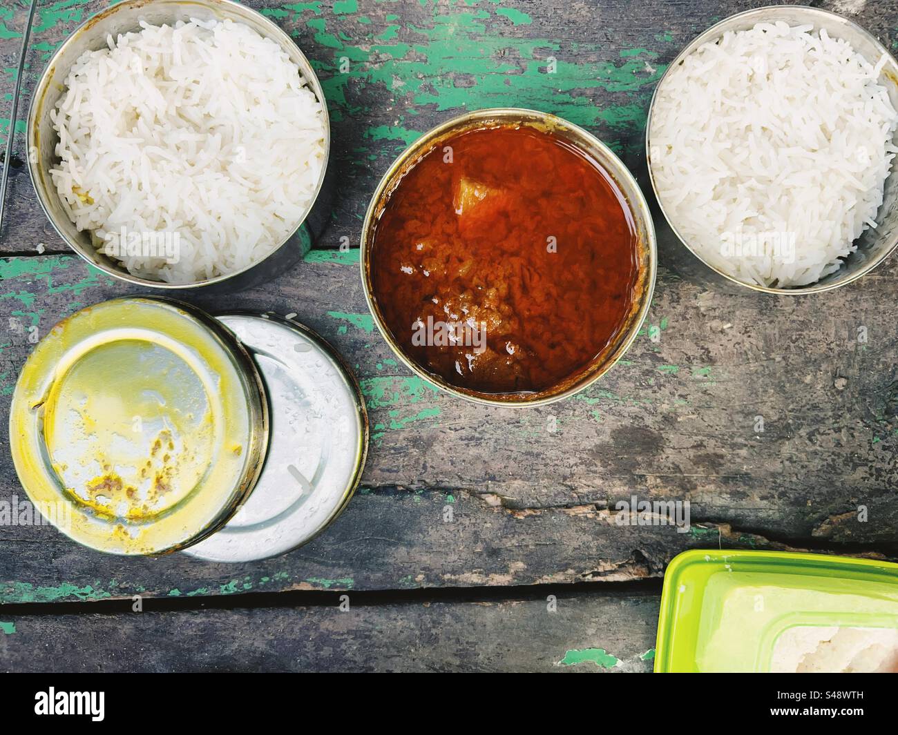 Indian spicy chicken curry and rice served in lunch boxes on a picnic table Stock Photo Alamy