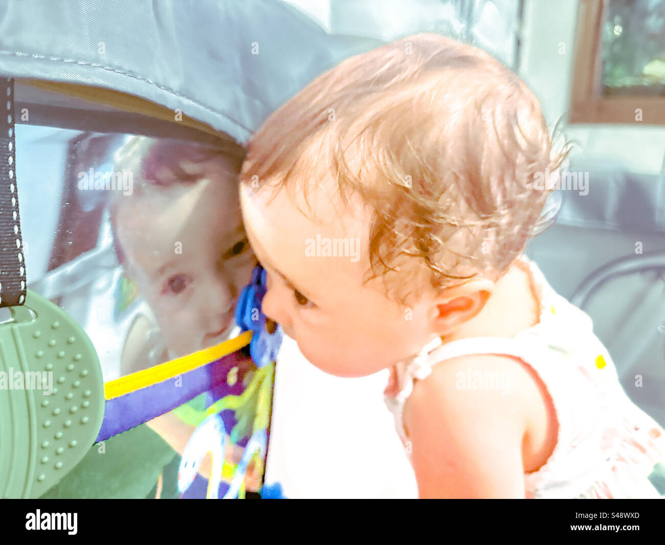 Baby looking in the mirror. Mirror play - Smartphone Captured Stock Image