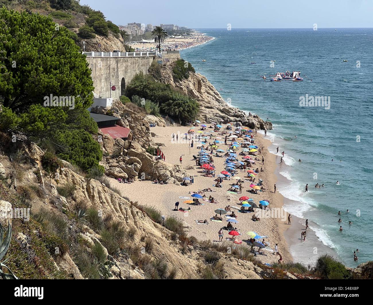 Busy beach in Calella, Costa Brava, Spain - Smartphone Captured Stock Image