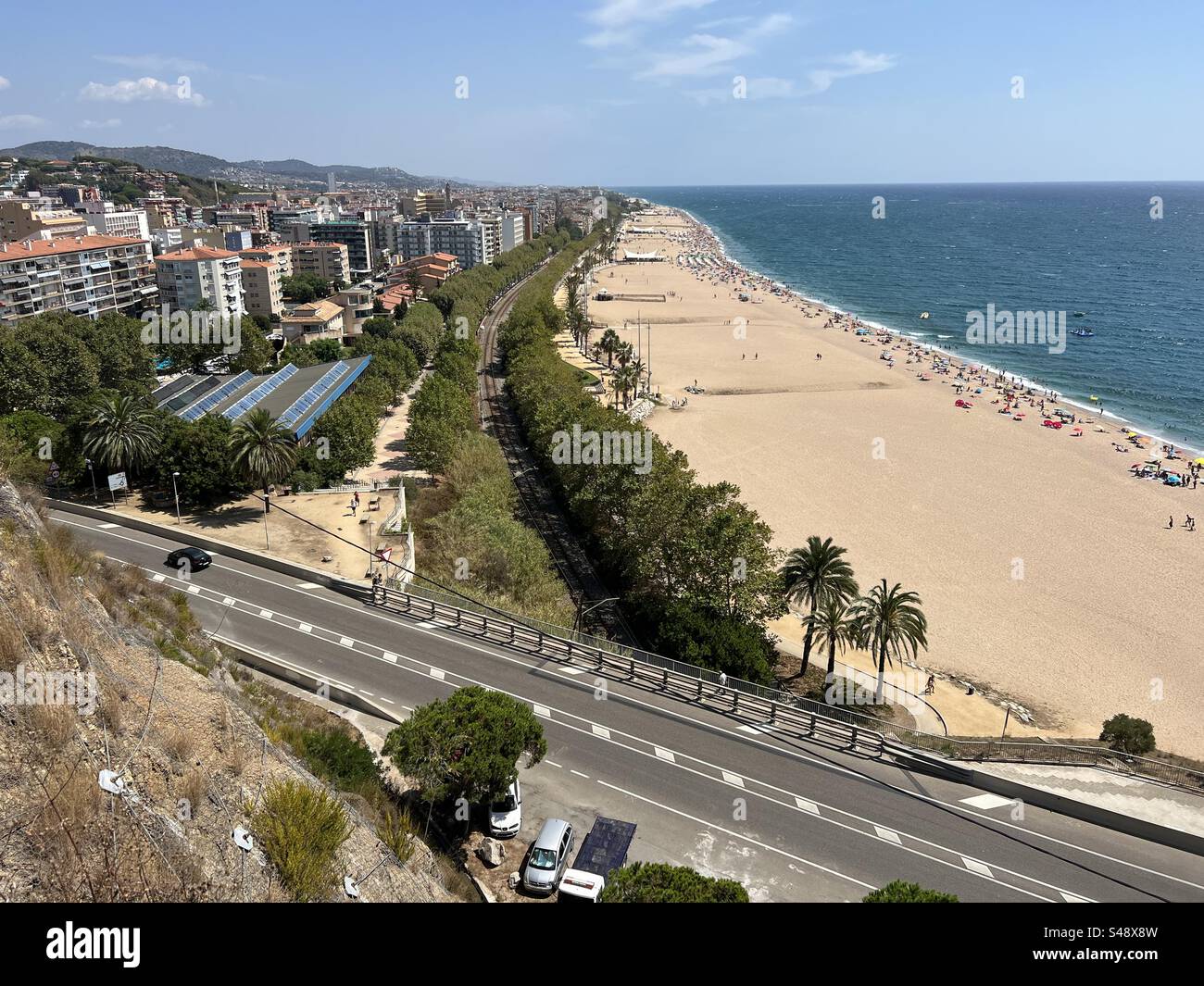 A coastal road passing by the beach in Callela, Costa Brava, Spain - Smartphone Captured Stock Image