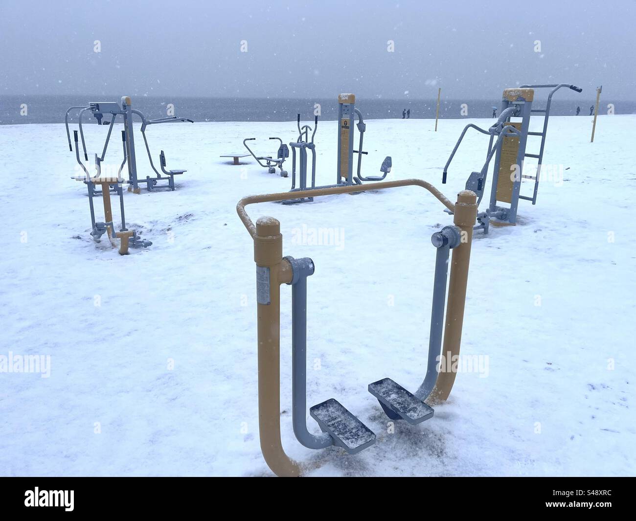 Outdoor gym equipment on the snow covered Gdansk Beach, Baltic Sea, Gdansk, Poland, Europe - Smartphone Captured Stock Image
