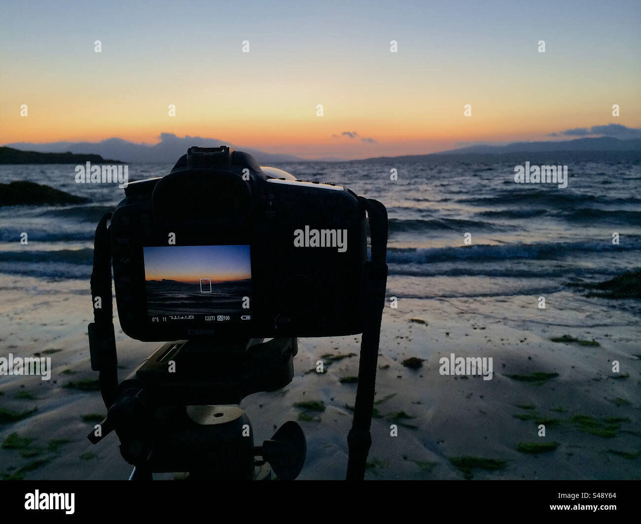 Canon SLR in action beach sunrise Stock Photo