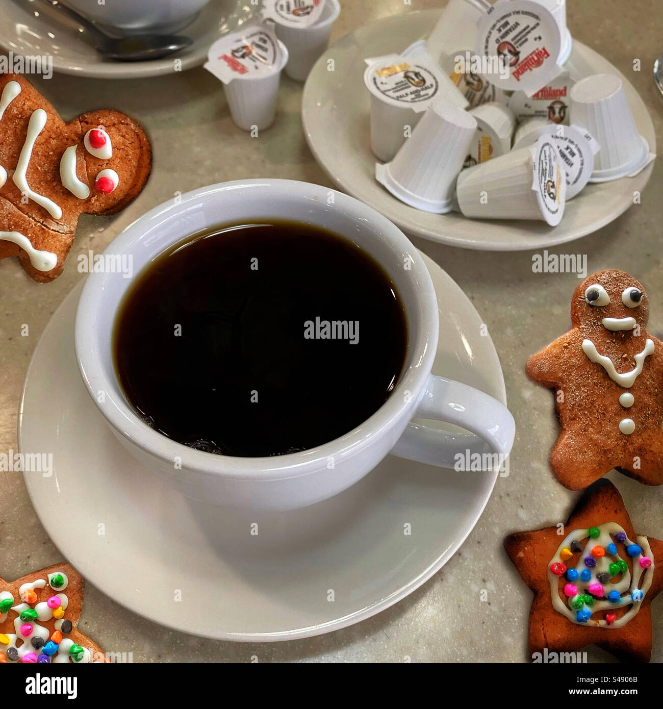 Cup of black coffee and Christmas cookies on a diner table top Stock Photo
