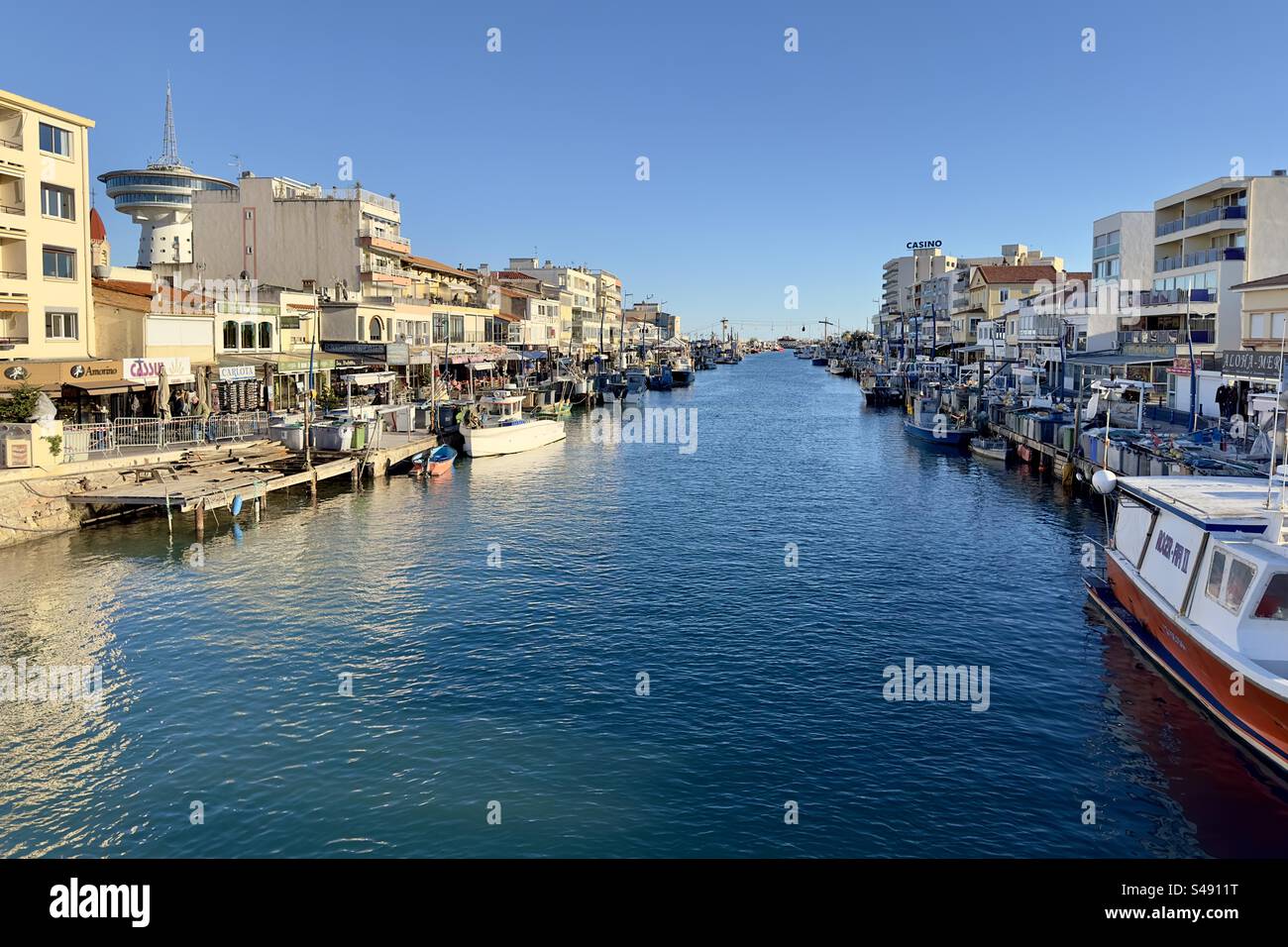 High resolution landscape photo of the canal in Palavas, with its fishing boats, restaurants and beautiful weather. - Smartphone Captured Stock Image