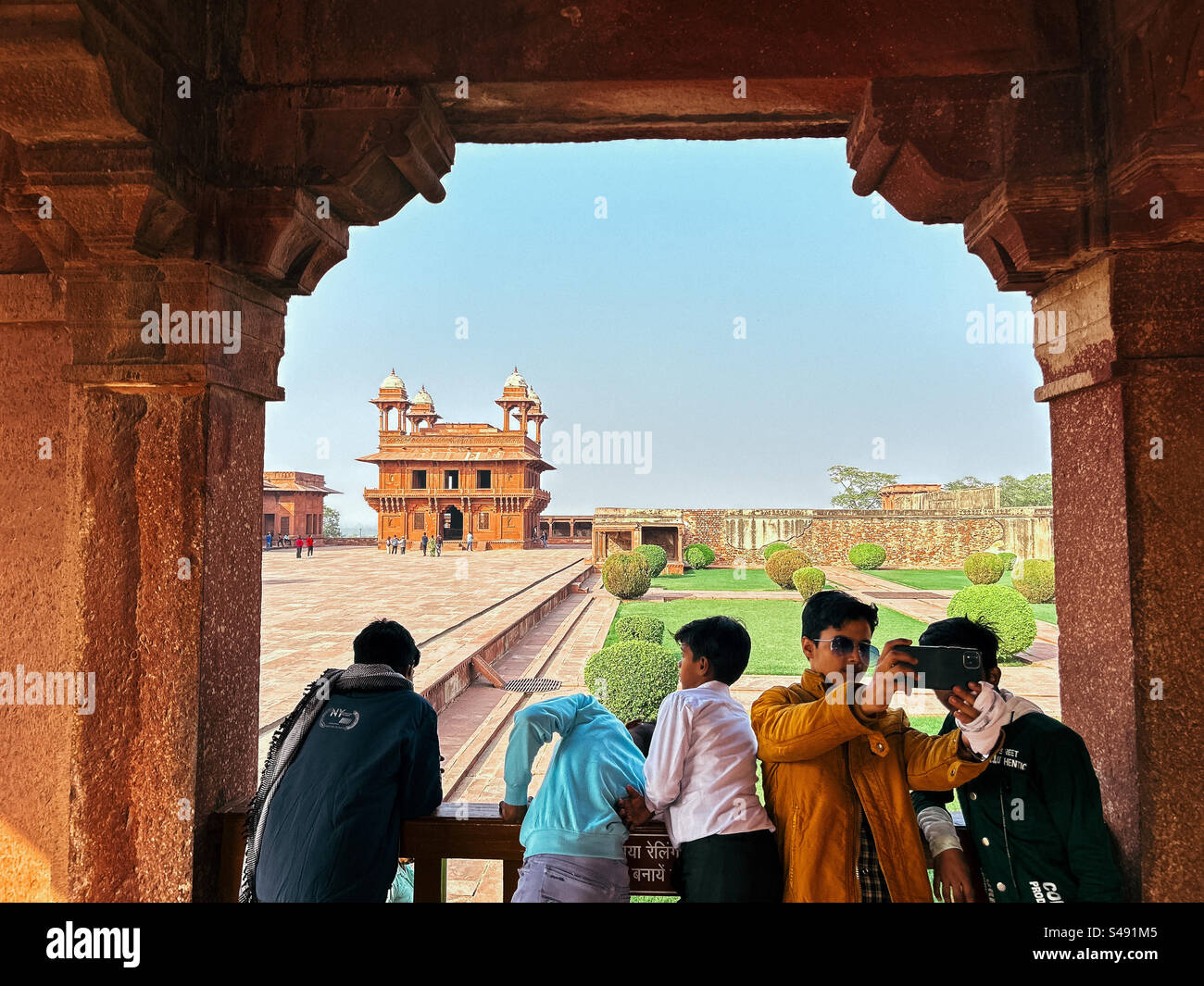 Indian tourists at Emperor Akbar’s palace in India at Fatehpur Sikri, a UNESCO World Heritage Site - Smartphone Captured Stock Image