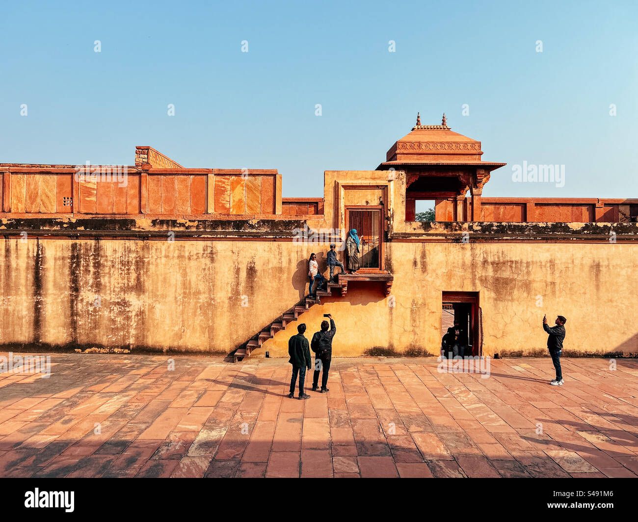 Indian tourists at Emperor Akbar’s palace in India at Fatehpur Sikri, a UNESCO World Heritage Site - Smartphone Captured Stock Image