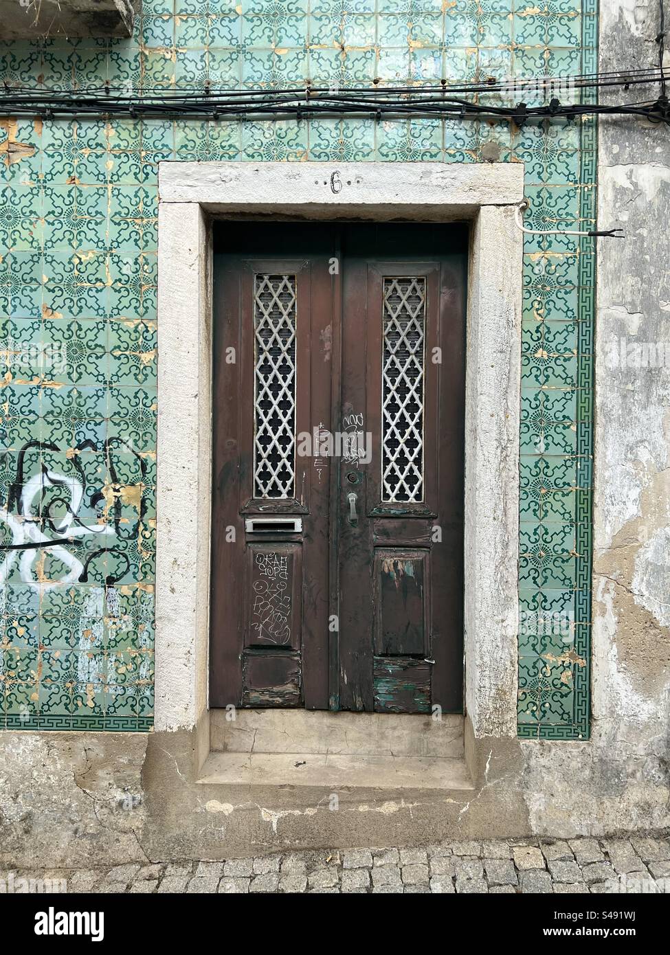 Old door and green tiles Stock Photo