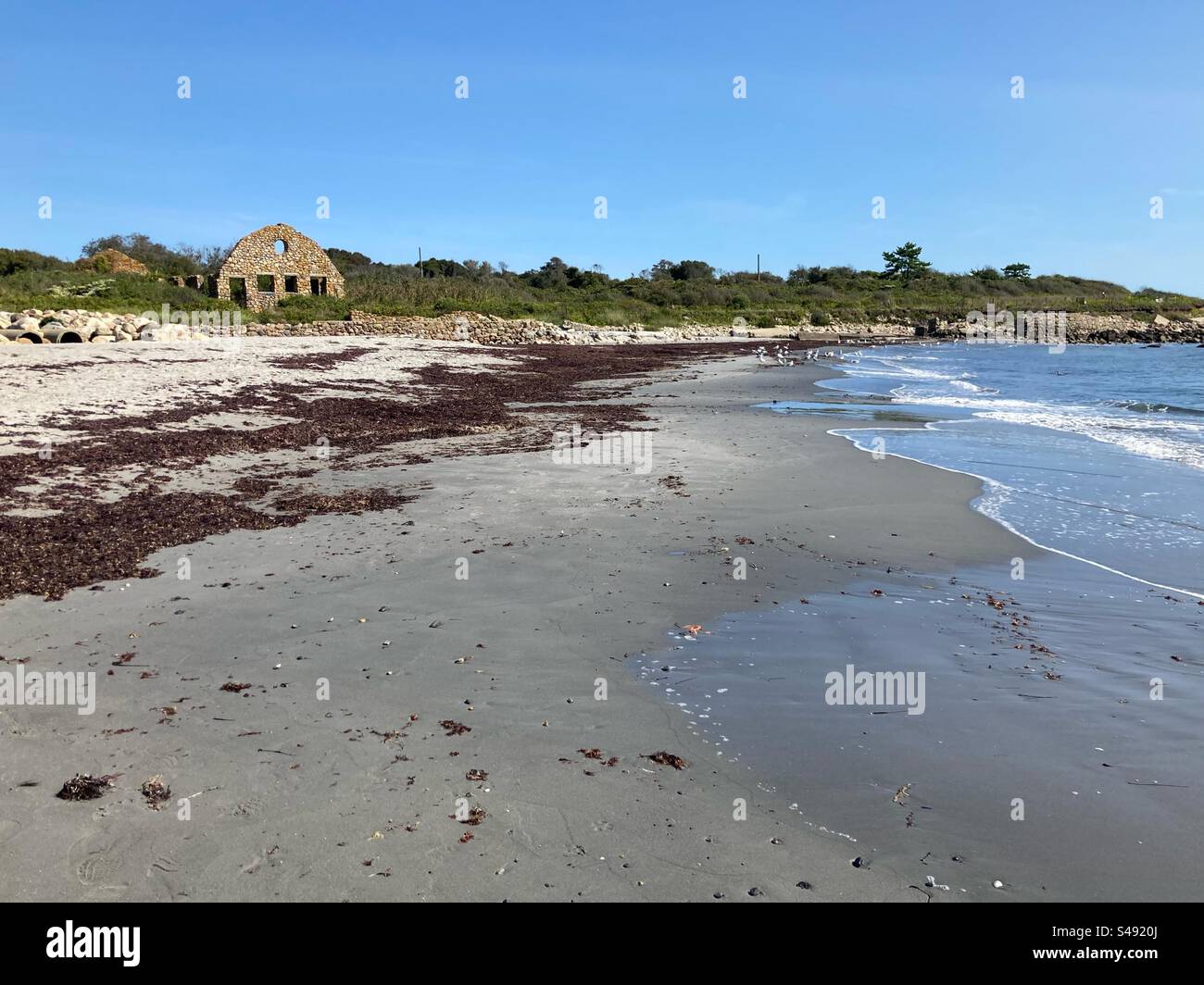 Scarborough South State Beach in Narragansett, Rhode Island, USA.  Remnants of a stone building in the distance. Atlantic Ocean scene. - Smartphone Captured Stock Image