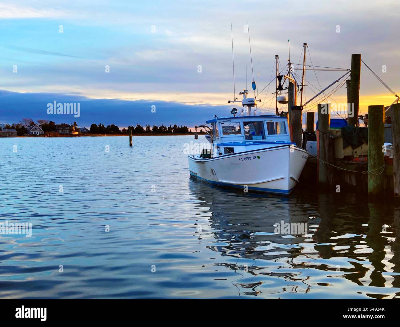 Boat at a pier during sunset, in Clinton Harbor. Located in Clinton