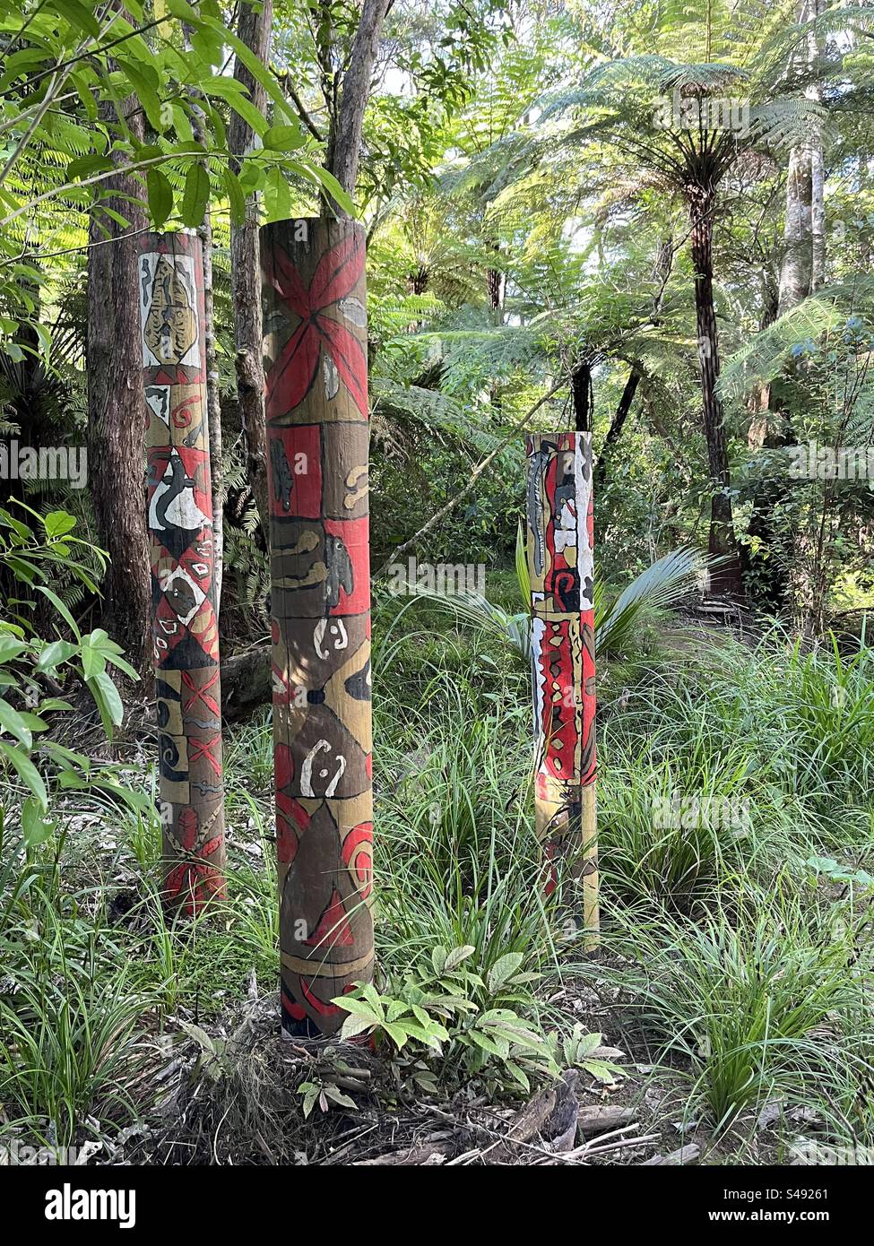 Totem poles on bush walk pay homage to the trees Stock Photo