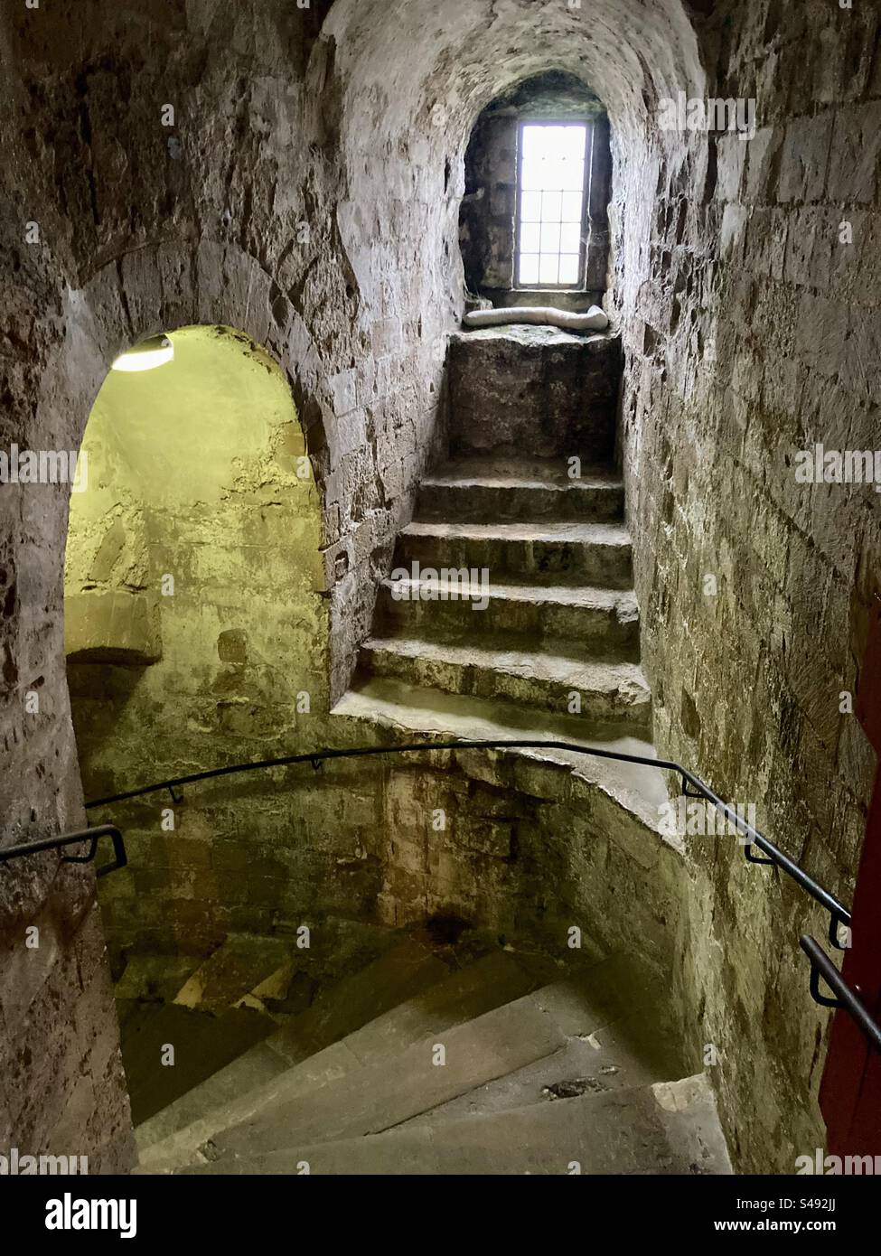 Heading down a spiral stone staircase in Dover Castle Stock Photo