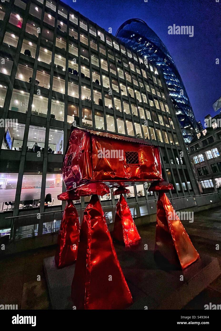 The Granary sculpture by Jesse Pollock. Red sheet metal. Surrounded by modern offices in the City of London at night - Smartphone Captured Stock Image